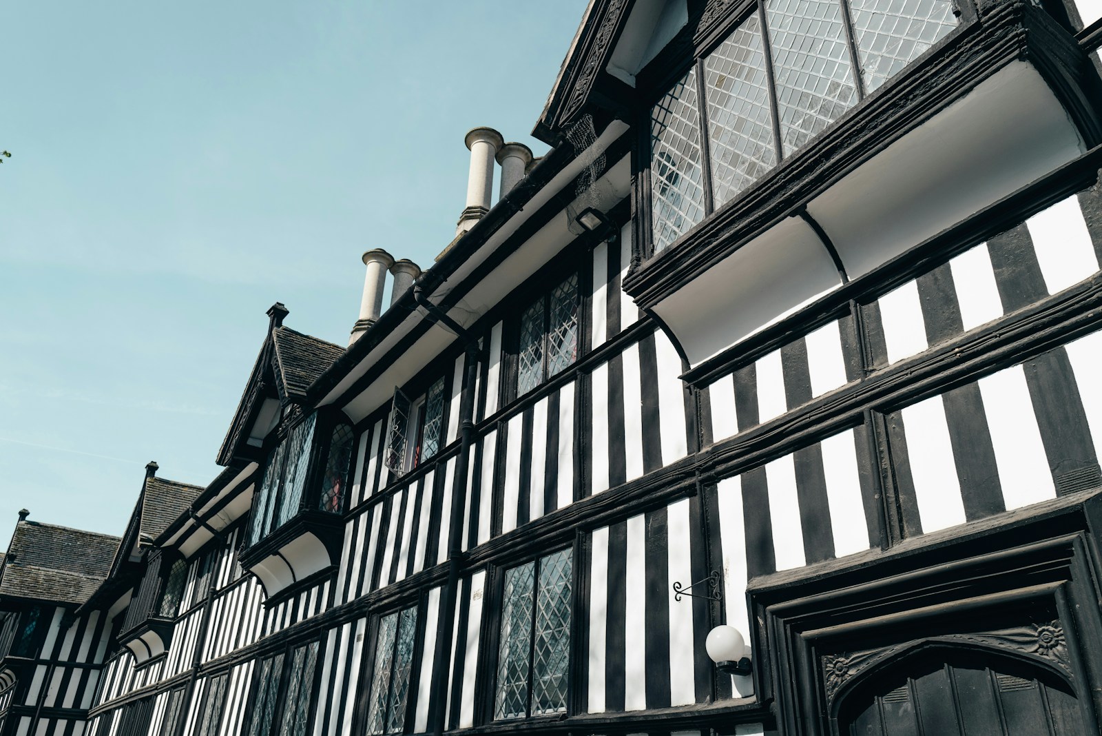 white and black house during daytime World War II Roman Empire Victorian Era Tudor Period Ancient Greece Ancient China Viking Age French Revolution Industrial Revolution Cold War